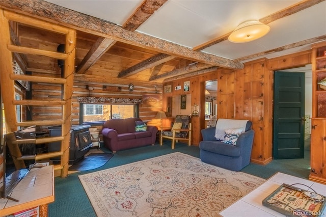 carpeted living room with wooden walls, beam ceiling, and a wood stove