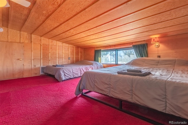 bedroom featuring carpet flooring, vaulted ceiling, and wood walls