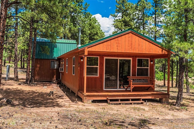 exterior space featuring a deck and metal roof