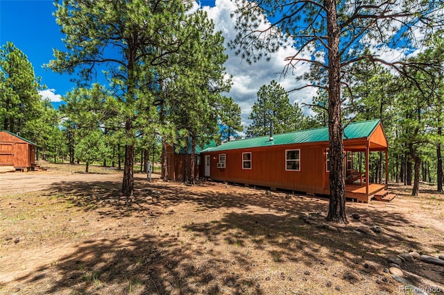 view of property exterior featuring metal roof