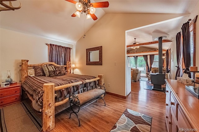 bedroom featuring lofted ceiling, baseboards, light wood-style floors, and ceiling fan