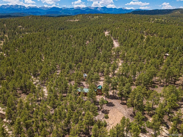 aerial view featuring a view of trees and a mountain view
