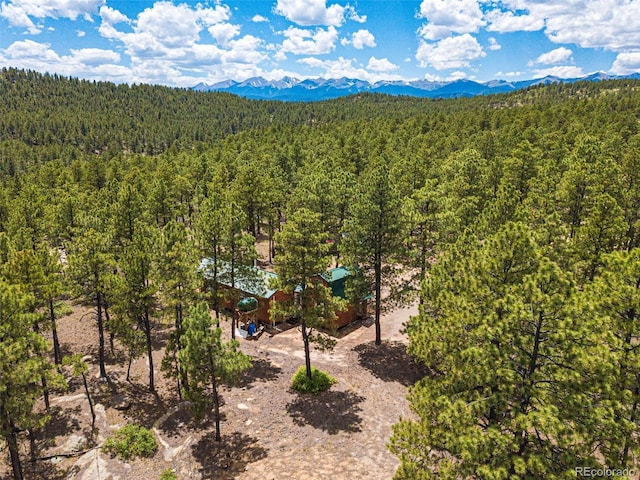 drone / aerial view with a forest view and a mountain view