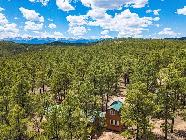 bird's eye view featuring a forest view and a mountain view