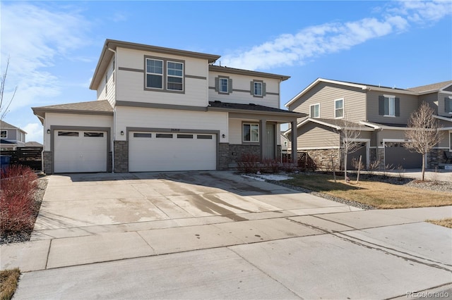 view of front of property with a garage, stone siding, and concrete driveway