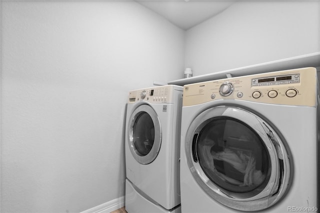 washroom with laundry area, baseboards, and independent washer and dryer