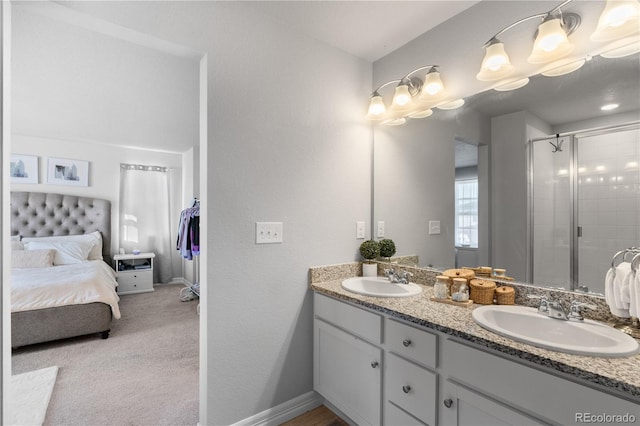 full bathroom featuring a sink, ensuite bath, a stall shower, and double vanity