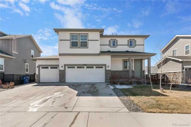 view of front of house with a porch, fence, stone siding, concrete driveway, and a garage
