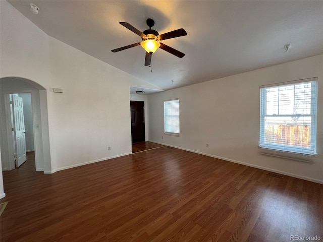 spare room featuring ceiling fan, dark hardwood / wood-style floors, and vaulted ceiling