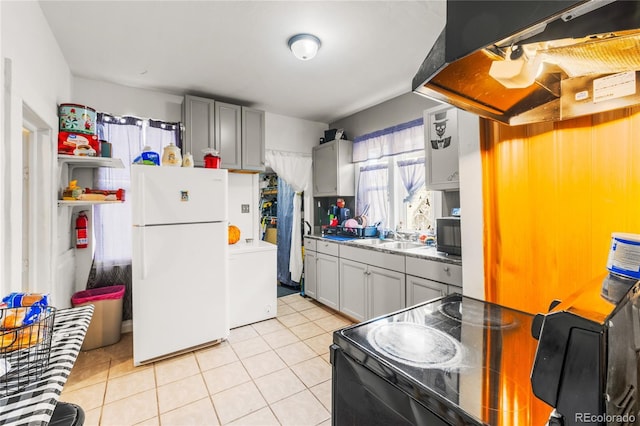 609 W 8th St Unit 611, Pueblo, CO 81003 - kitchen with black appliances, washer / clothes dryer, extractor fan, a sink, and light tile patterned floors