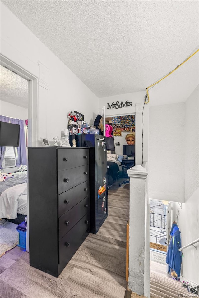 609 W 8th St Unit 611, Pueblo, CO 81003 - bedroom featuring a textured ceiling, wood finished floors, a closet, and a spacious closet