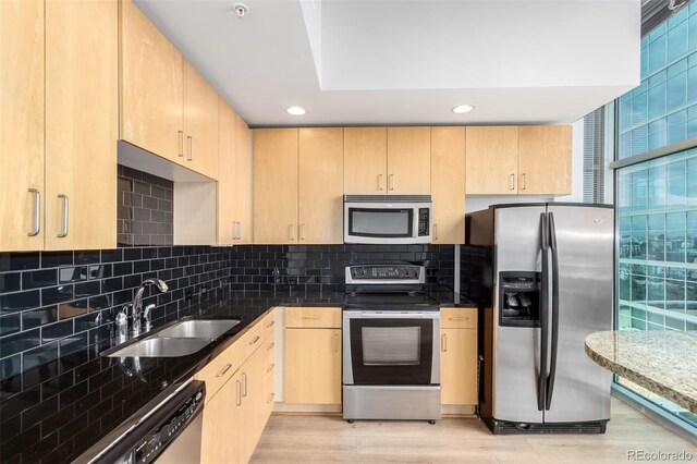 1700 Bassett St Unit 1102, Denver, CO 80202 - kitchen with appliances with stainless steel finishes, light brown cabinets, a sink, recessed lighting, and decorative backsplash