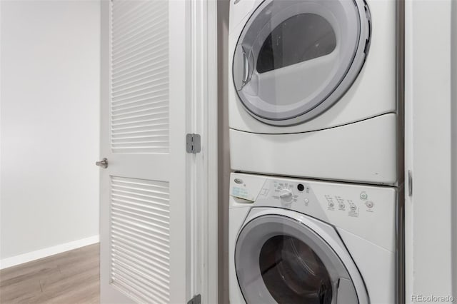 1700 Bassett St Unit 1102, Denver, CO 80202 - laundry room with estacked washer and dryer, light wood finished floors, and baseboards
