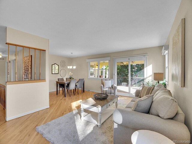 6844 S Detroit Cir, Centennial, CO 80122 - living area featuring wood finished floors and a chandelier