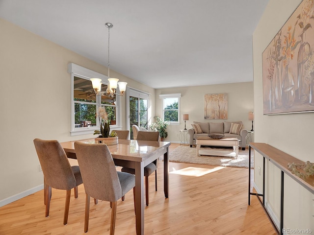6844 S Detroit Cir, Centennial, CO 80122 - dining area with light wood-style floors and a chandelier
