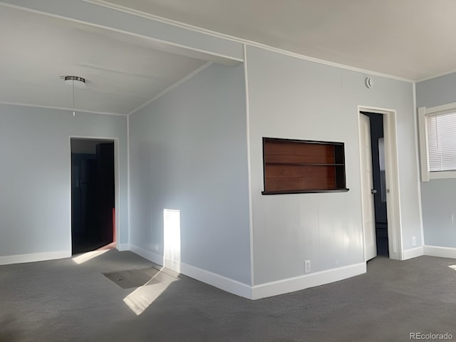 carpeted spare room with ornamental molding and baseboards