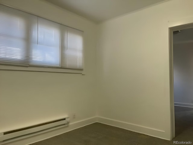 spare room with a baseboard radiator and baseboards