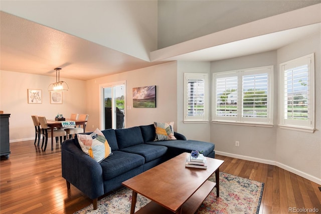 living room featuring wood-type flooring and baseboards