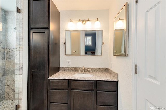 full bathroom with a stall shower and vanity
