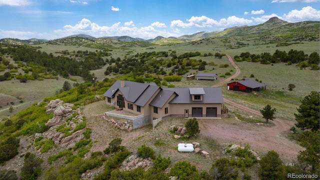 birds eye view of property with a mountain view