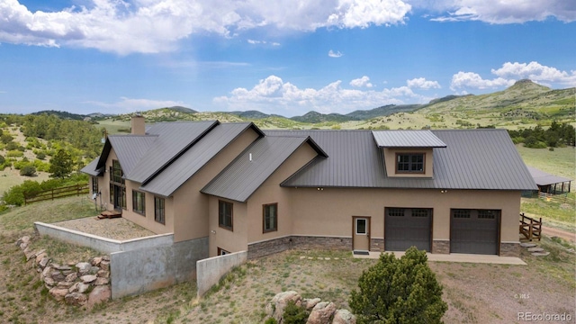 view of front of home featuring a garage and a mountain view