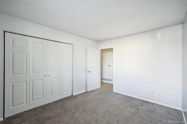 unfurnished bedroom with a closet and carpet