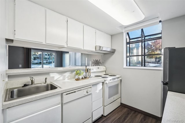 12470 E Cornell Ave Unit 104, Aurora, CO 80014 - kitchen featuring white appliances, ventilation hood, light countertops, white cabinets, and dark wood-style floors