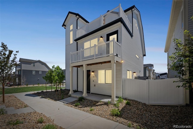 18211 E 51st Ave, Denver, CO 80249 - view of front facade with a balcony, fence, and board and batten siding
