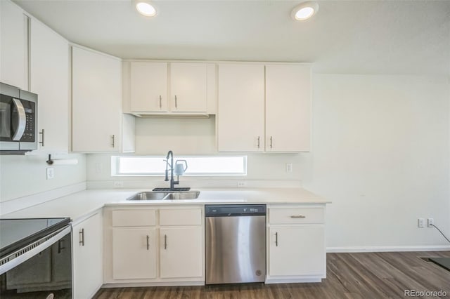 18211 E 51st Ave, Denver, CO 80249 - kitchen with stainless steel appliances, a sink, light countertops, dark wood-style flooring, and recessed lighting