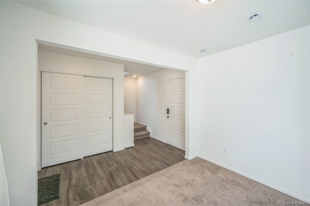 18211 E 51st Ave, Denver, CO 80249 - unfurnished bedroom featuring a closet, baseboards, and wood finished floors