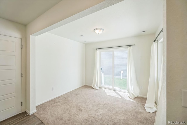 18211 E 51st Ave, Denver, CO 80249 - unfurnished bedroom featuring access to outside, baseboards, and carpet floors