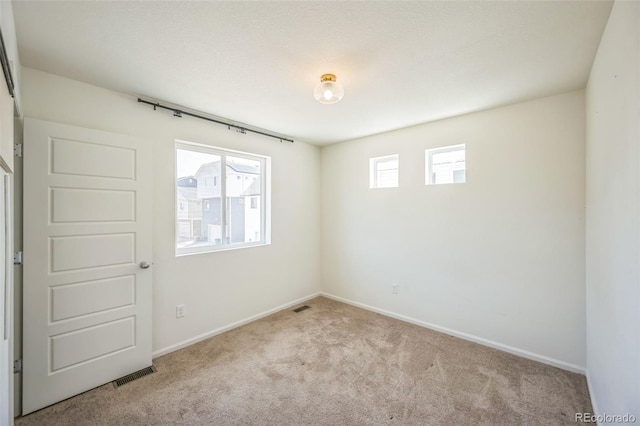 18211 E 51st Ave, Denver, CO 80249 - spare room with carpet flooring and baseboards
