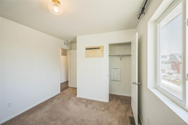 18211 E 51st Ave, Denver, CO 80249 - unfurnished bedroom featuring multiple windows, carpet, baseboards, and a closet