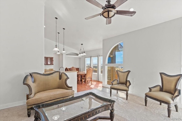 carpeted living room with ceiling fan