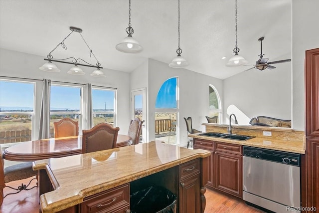 kitchen with ceiling fan, sink, hanging light fixtures, stainless steel dishwasher, and light wood-type flooring