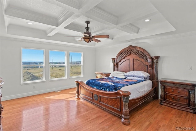 bedroom with ceiling fan, coffered ceiling, beamed ceiling, crown molding, and light hardwood / wood-style floors