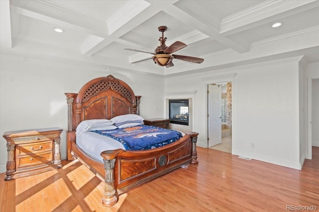 bedroom with beam ceiling, connected bathroom, ceiling fan, and coffered ceiling