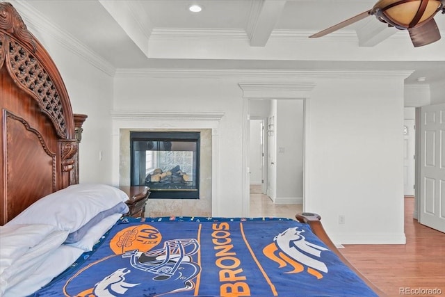 bedroom with hardwood / wood-style flooring, ceiling fan, and crown molding