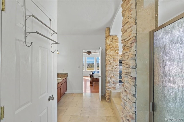 bathroom with tile patterned floors, ceiling fan, a shower with door, and vanity