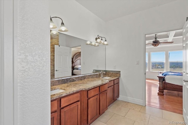 bathroom with tile patterned floors, coffered ceiling, vanity, ceiling fan, and beamed ceiling