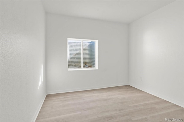 empty room with light hardwood / wood-style flooring