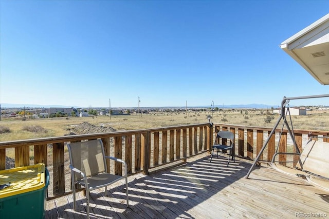 wooden deck with a rural view