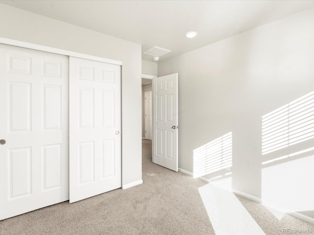 interior space with light carpet and a closet