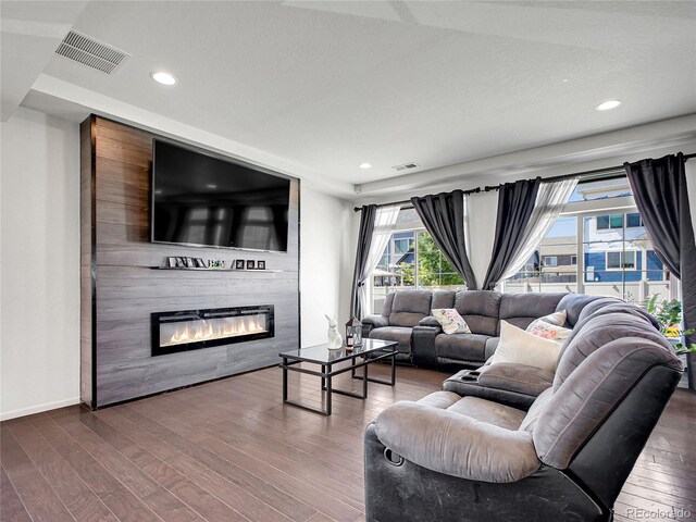 19155 Robins Dr, Denver, CO 80249 - living room with wood finished floors, a large fireplace, and recessed lighting