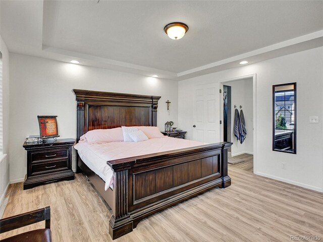 19155 Robins Dr, Denver, CO 80249 - bedroom featuring light wood-type flooring, a tray ceiling, and recessed lighting