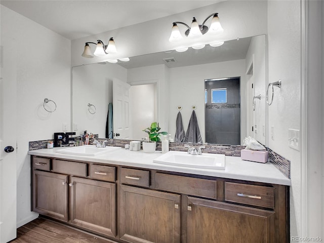 19155 Robins Dr, Denver, CO 80249 - bathroom featuring double vanity and wood finished floors