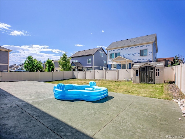 19155 Robins Dr, Denver, CO 80249 - fenced backyard with a patio, a shed, and a residential view