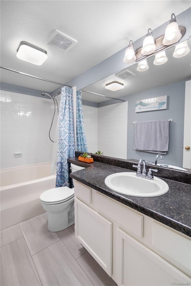 full bathroom featuring vanity, shower / bath combination with curtain, a textured ceiling, and toilet