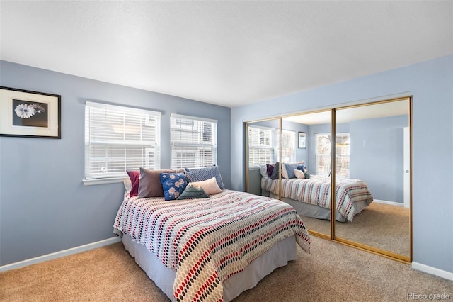 bedroom with a closet and light colored carpet