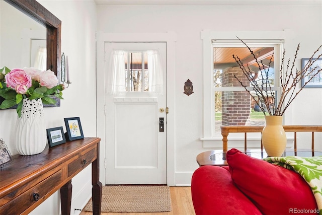 doorway to outside with light wood-style floors
